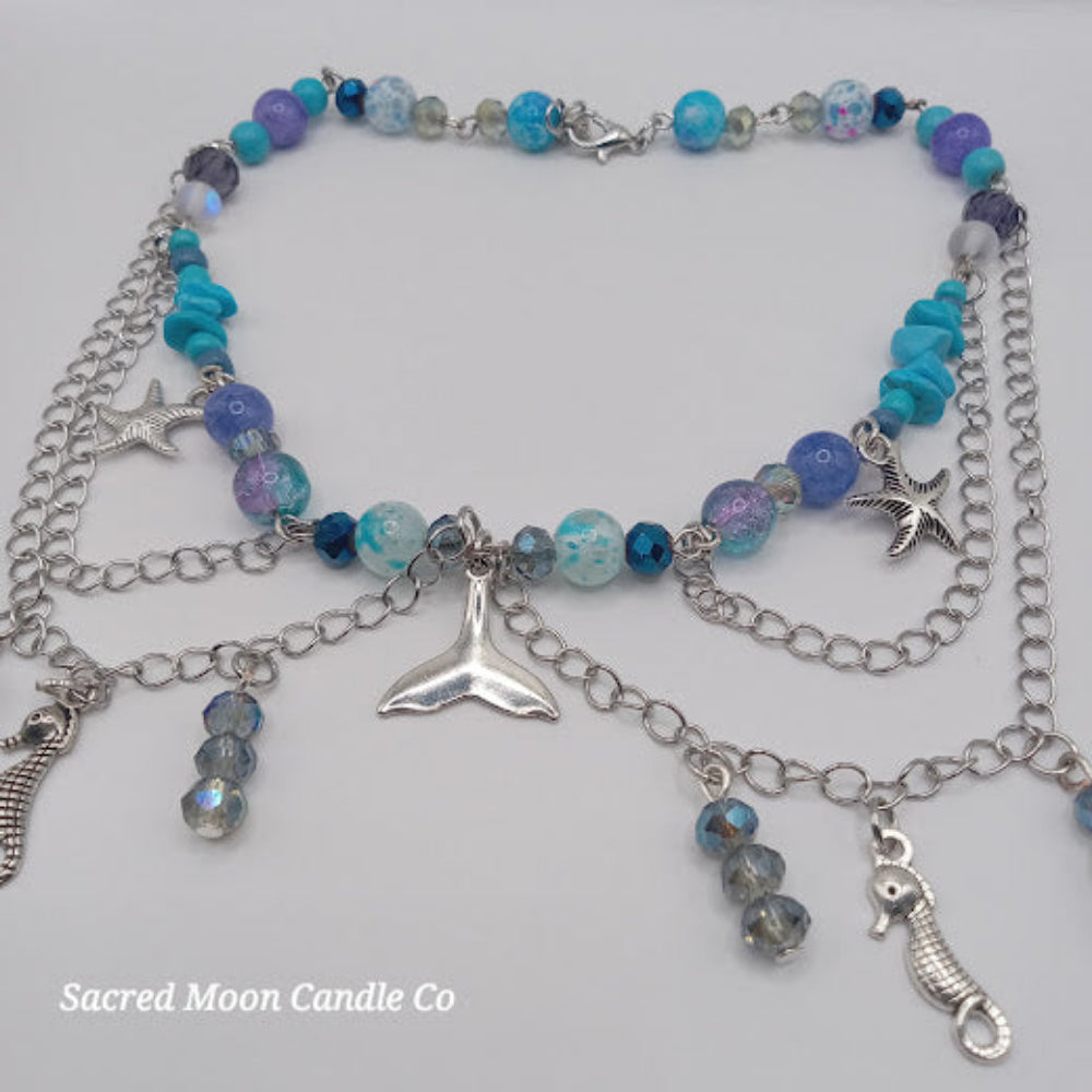 Colorful beaded mermaid tail choker necklace with silver sea charms and blue purple beads