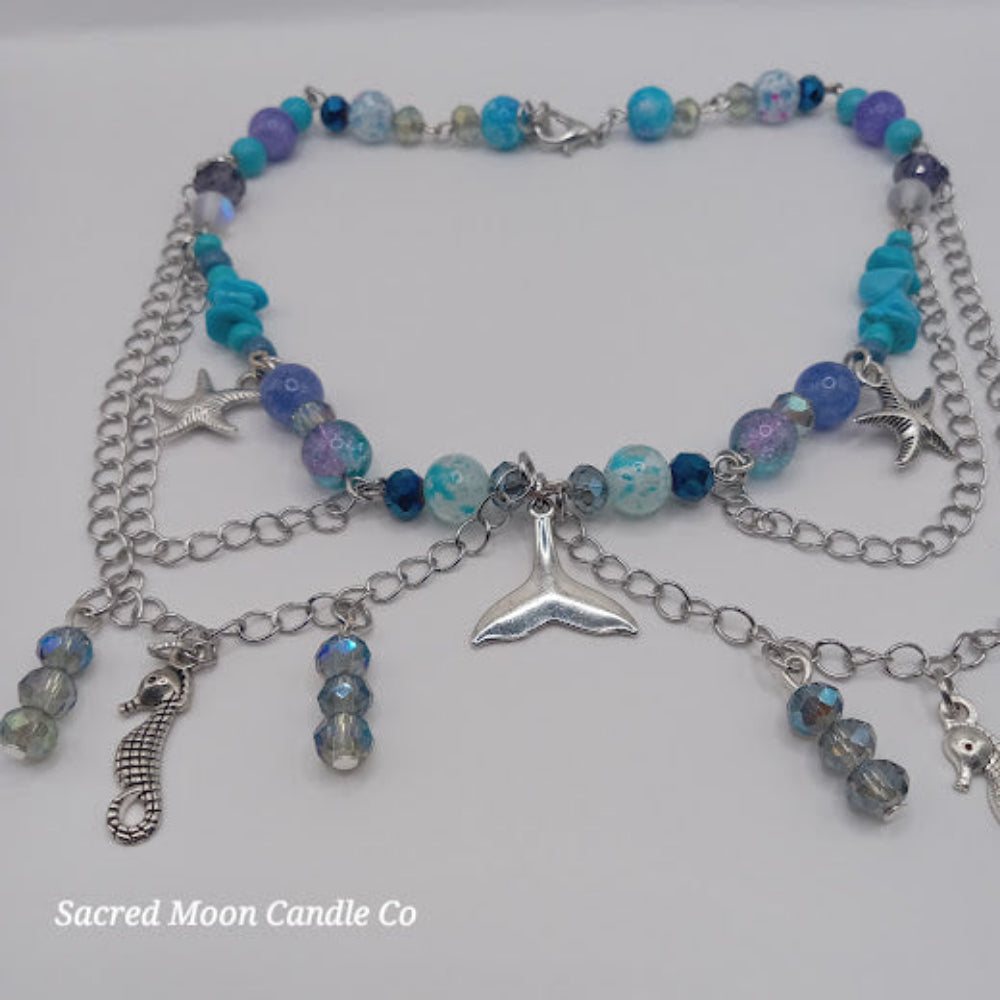 Sacred Moon Candle Co mermaid tail choker necklace with blue beads silver charms and chain accents