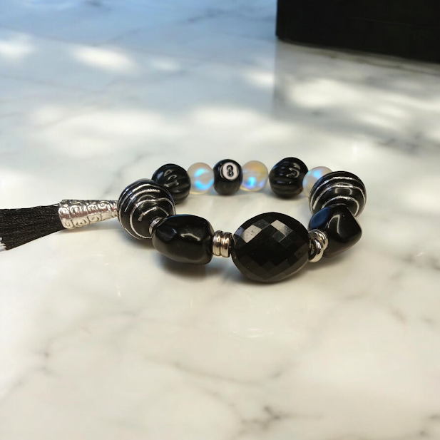 Sacred Moon Candle Co spiritual protection beaded bracelets featuring black and silver beads on a marble surface