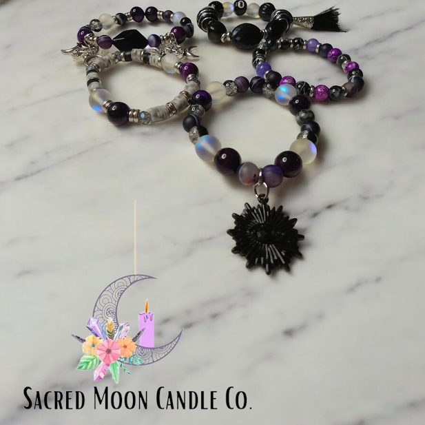 Spiritual protection beaded bracelets stack from Sacred Moon Candle Co with purple black and translucent beads