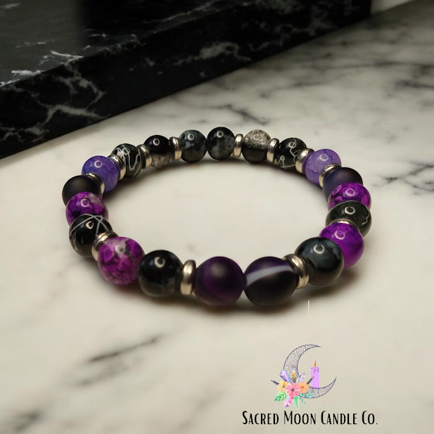 Sacred Moon Candle Co spiritual protection beaded bracelets stack with purple and black beads on marble surface