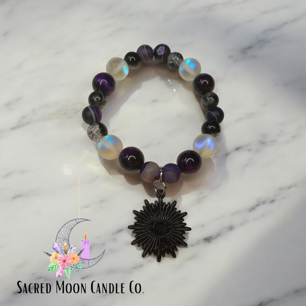 Sacred Moon Candle Co spiritual protection beaded bracelets stack with black sun charm and purple beads