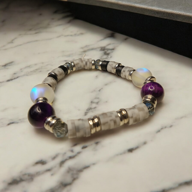Sacred Moon Candle Co spiritual protection beaded bracelets stack with purple and white beads on marble surface