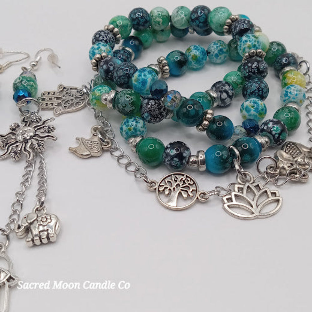 Teal boho earrings and bracelet stack with silver charms and green blue beads by Sacred Moon Candle Co