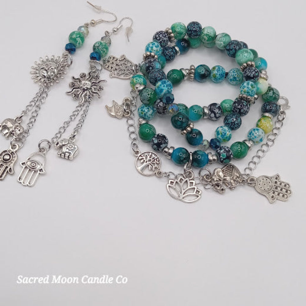 Teal boho earrings and bracelet stack with silver charms and blue green beads from Sacred Moon Candle Co