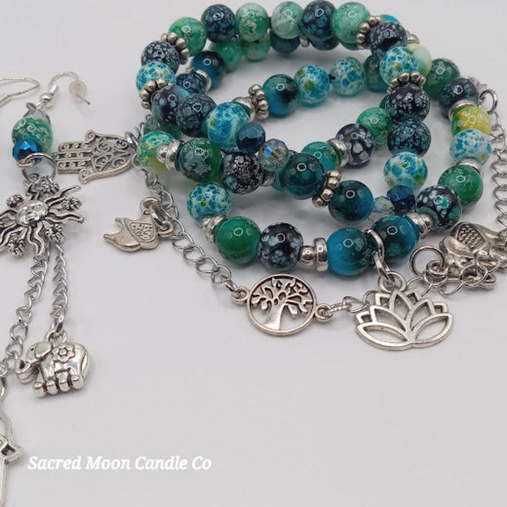 Teal boho earrings and bracelet stack with silver charms and blue-green beads by Sacred Moon Candle Co