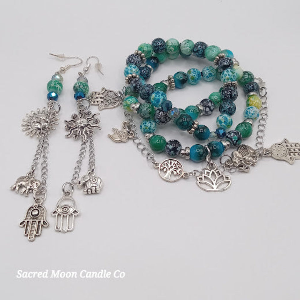 Sacred Moon Candle Co teal boho earrings and bracelet stack with silver charms and blue green beads