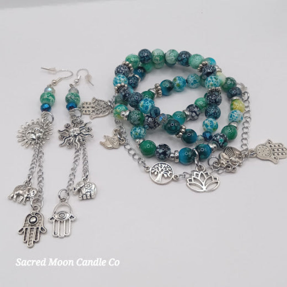 Sacred Moon Candle Co teal boho earrings and bracelet stack with silver charms and green blue beads