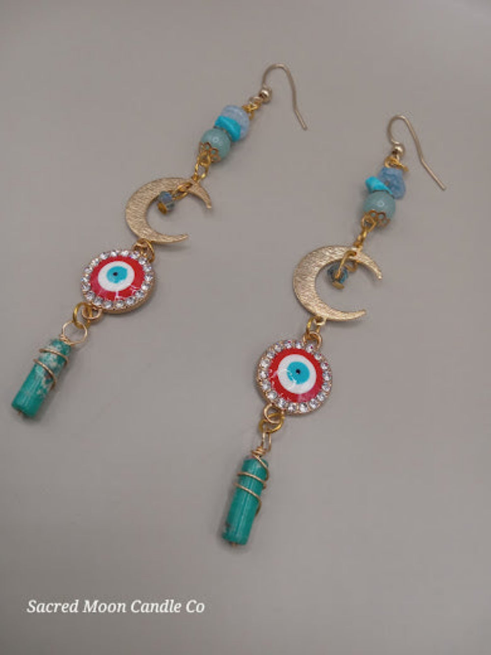 Sacred Moon Candle Co wire wrapped evil eye earrings with blue beads crescent moons and dangling turquoise stones