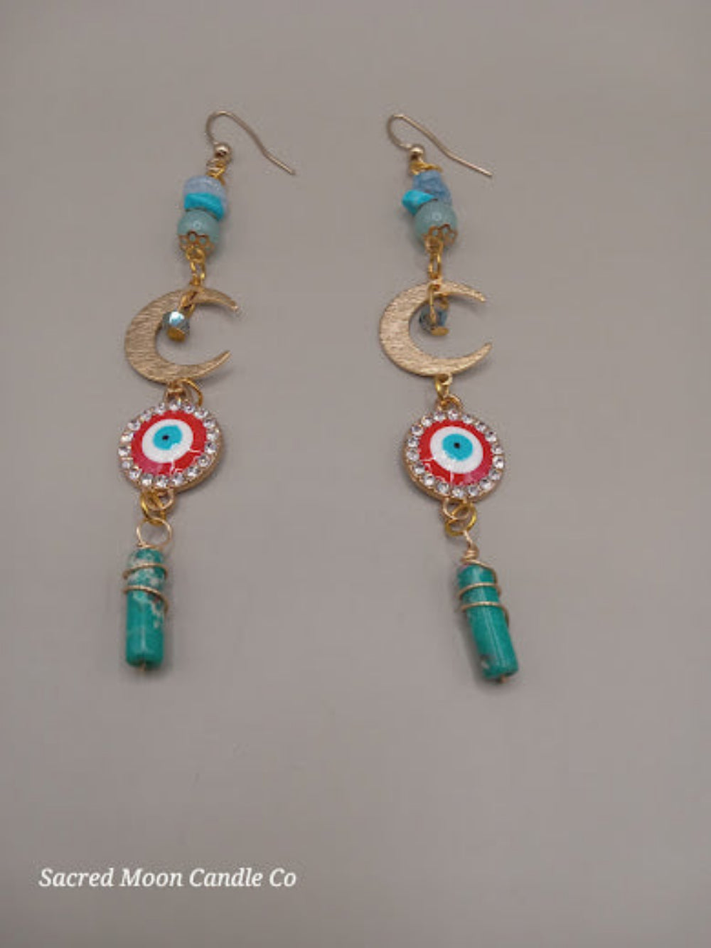 Sacred Moon Candle Co wire wrapped evil eye earrings with gold crescent moons and turquoise accents