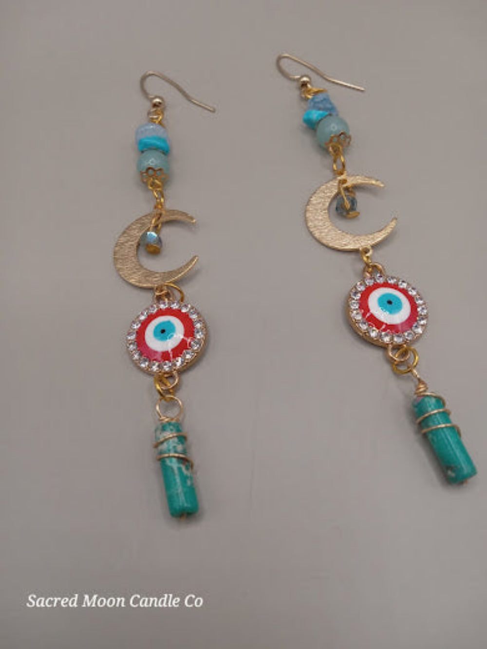 Sacred Moon Candle Co wire wrapped evil eye earrings with crescent moons and turquoise beads