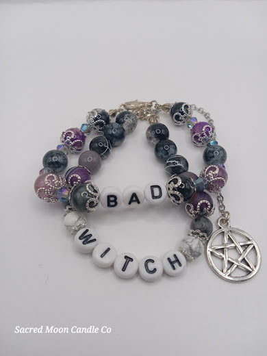 Sacred Moon Candle Co witch bracelet stack with black and purple beads and pentagram charm