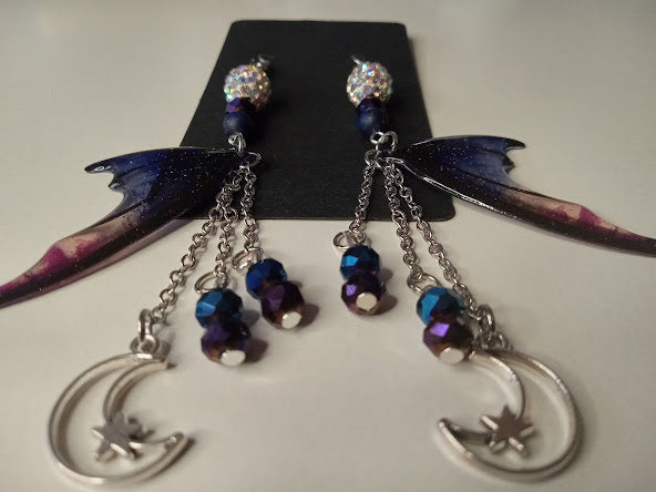 Blue magenta bat wing earrings by Sacred Moon Candle Co with silver crescent moons and dangling chains
