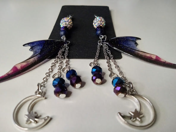 Sacred Moon Candle Co blue magenta bat wing earrings with dangling crescent moons and beads