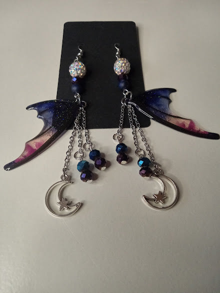 Sacred Moon Candle Co blue magenta bat wing earrings with moon charms and dangling beads