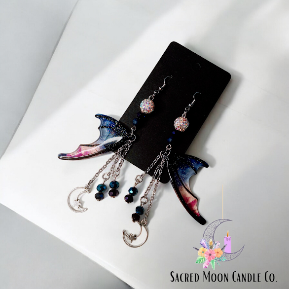 Blue magenta bat wing earrings with moon and star charms by Sacred Moon Candle Co