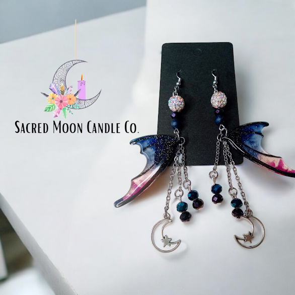 Blue magenta bat wing earrings with dangling moon and star charms by Sacred Moon Candle Co