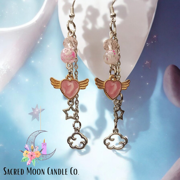 Sacred Moon Candle Co celestial dangle earrings with pink heart, star, and cloud charms