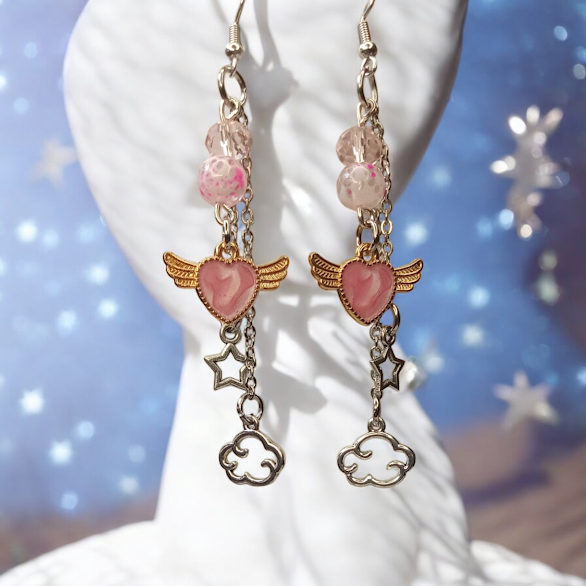 Sacred Moon Candle Co celestial dangle earrings with pink heart charms, wing accents, star and cloud charms