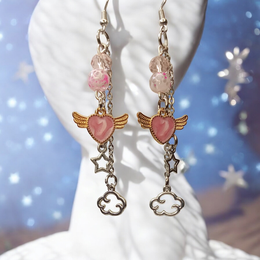 Sacred Moon Candle Co celestial dangle earrings with pink heart charms, wing accents, star and cloud charms