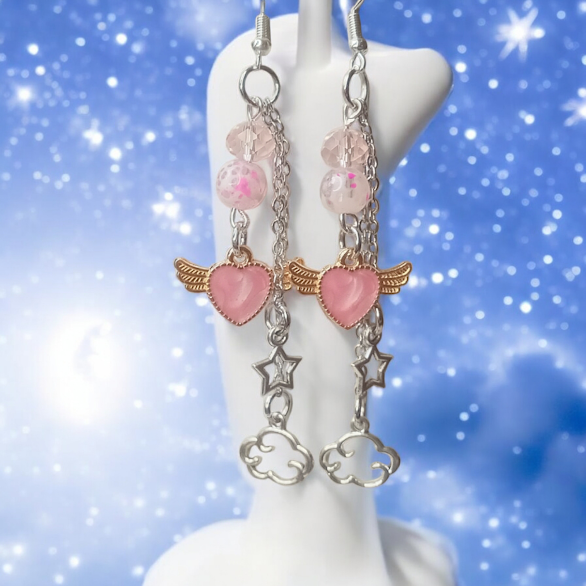 Sacred Moon Candle Co celestial dangle earrings with pink hearts, star charms, and cloud pendants