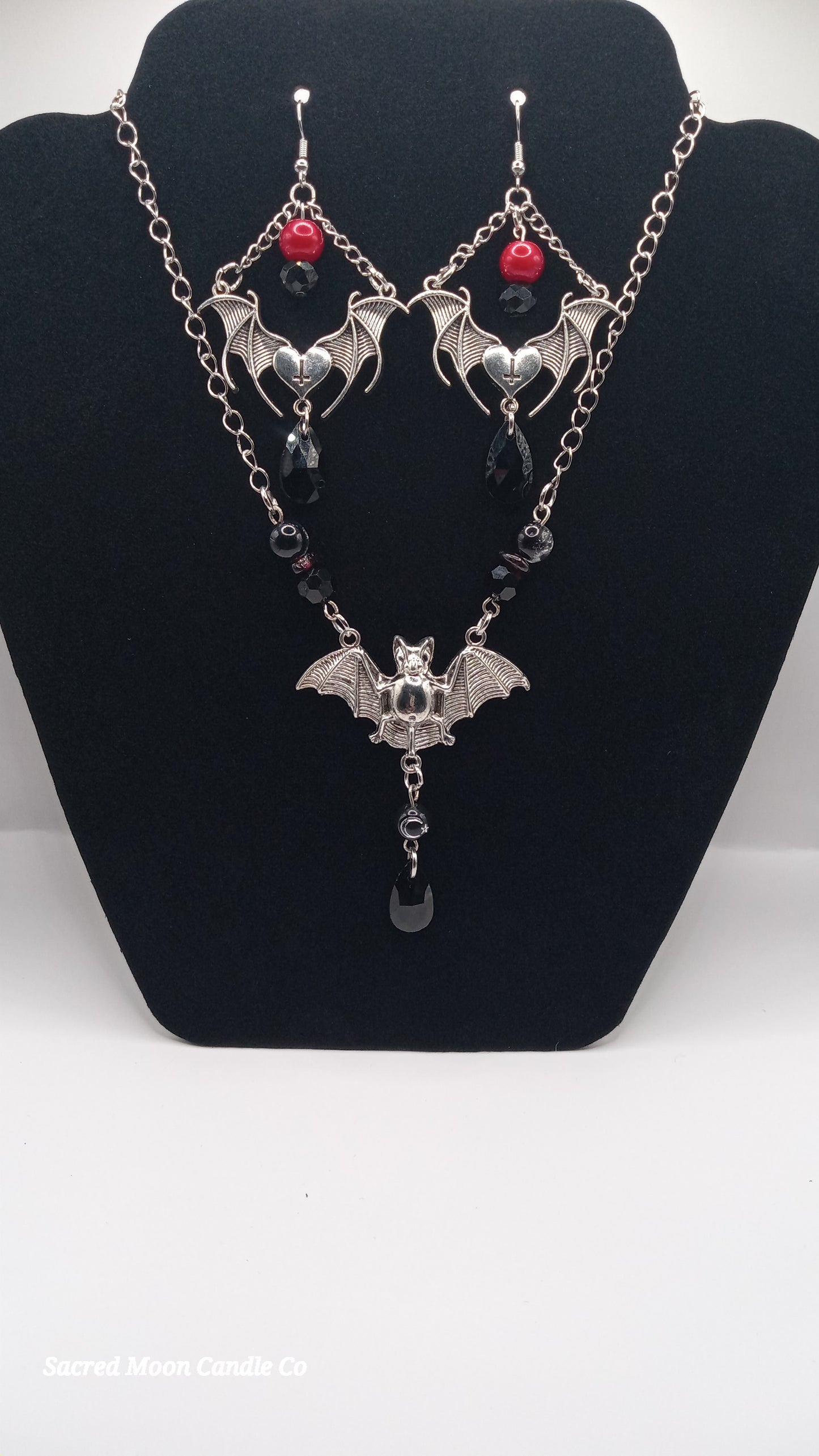 Sacred Moon Candle Co gothic bat jewelry set with silver bat earrings and matching bat necklace with red and black beads