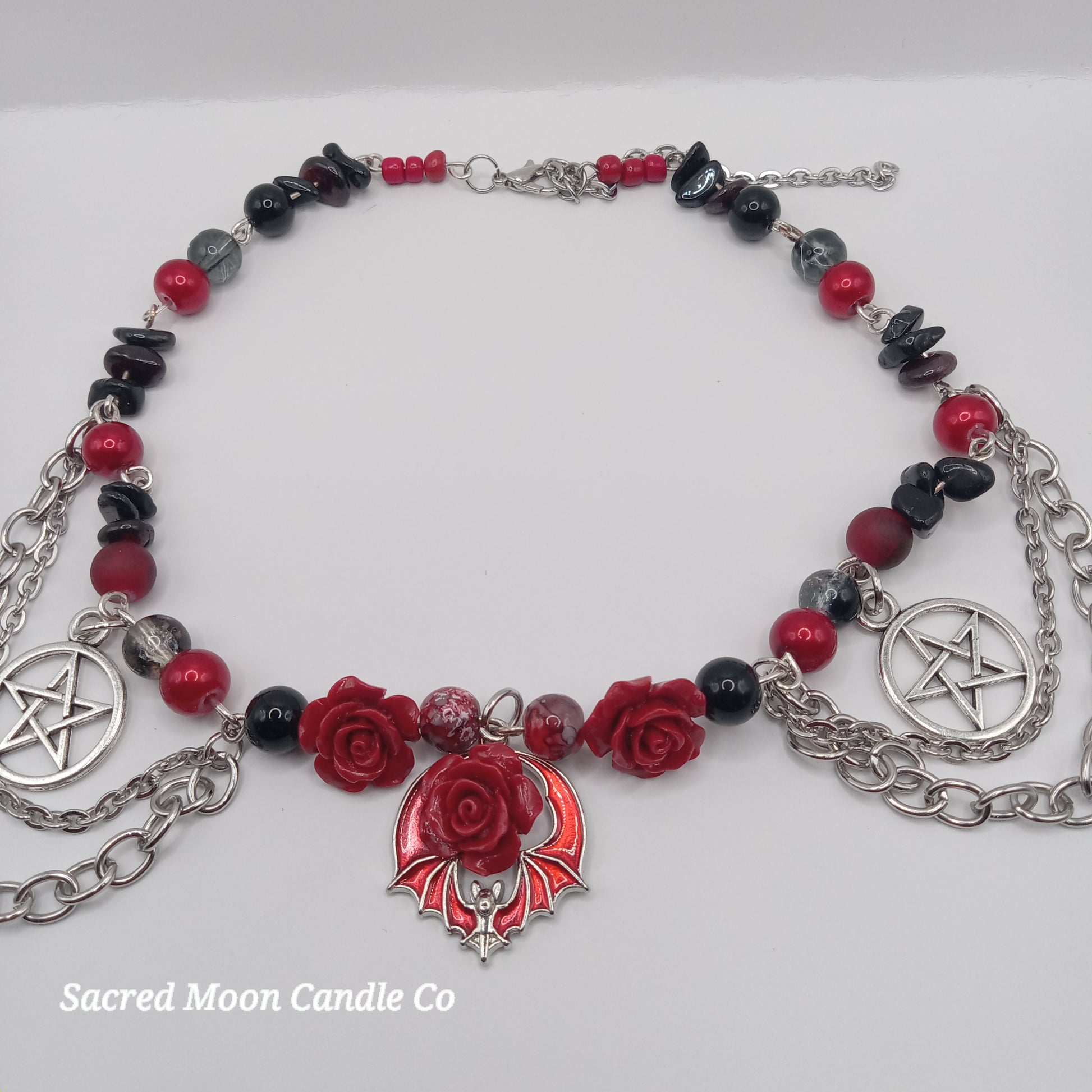 Handmade rose bat choker by Sacred Moon Candle Co with red roses, bat pendant, red and black beads and silver chains