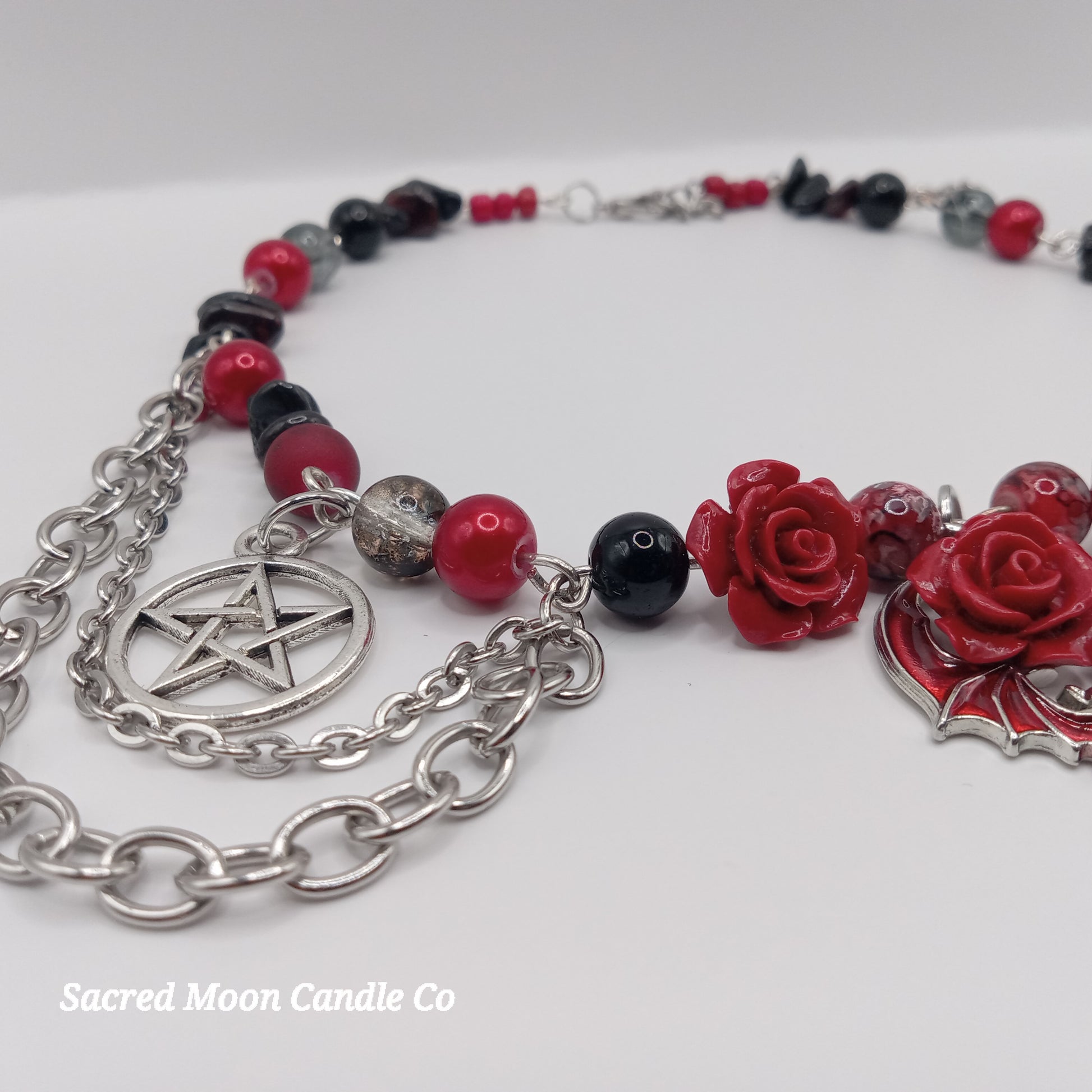 Handmade rose bat choker with red rose charms, black and red beads, and silver pentagram chain