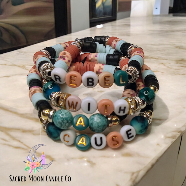 Rebel With A Cause bracelet stack featuring colorful beads and gold letter accents by Sacred Moon Candle Co