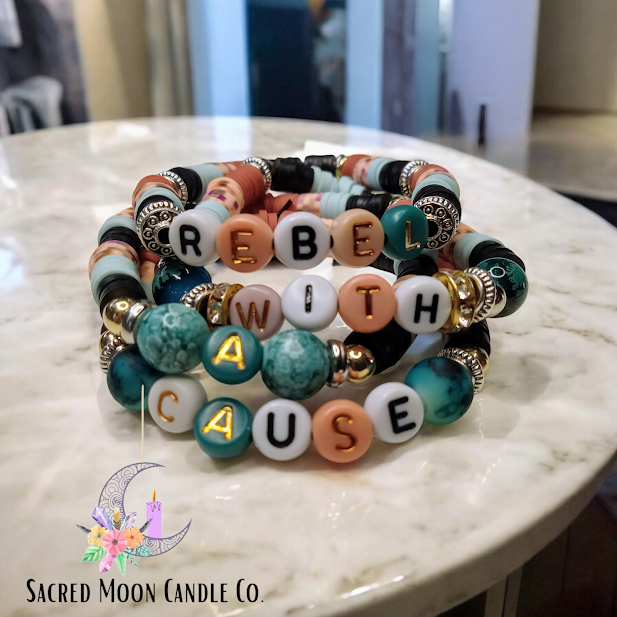 Rebel With A Cause bracelet stack featuring multicolored beads and gold accents from Sacred Moon Candle Co