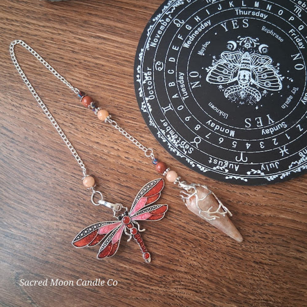 Sunstone dragonfly pendulum for divination with red wings and stone bead chain from Sacred Moon Candle Co
