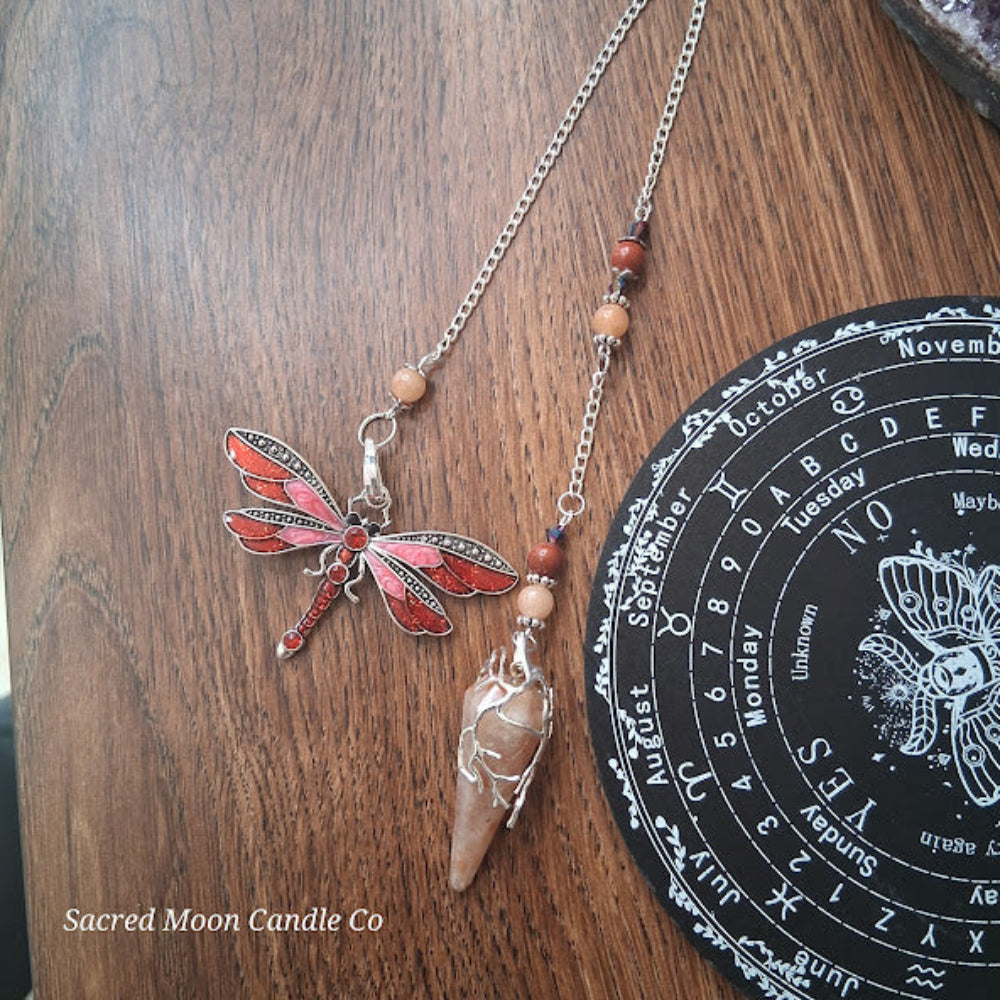 Sunstone dragonfly pendulum for divination with detailed red dragonfly and stone on silver chain by Sacred Moon Candle Co