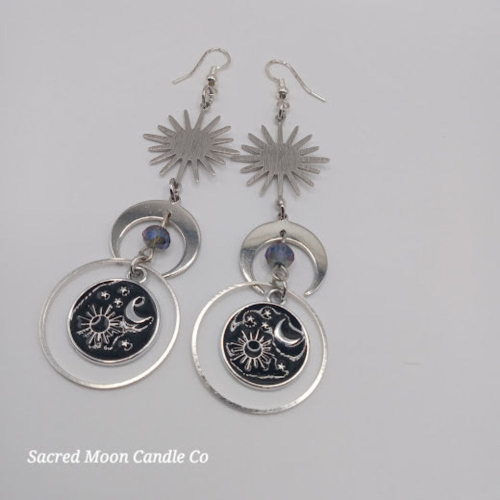 Celestial earrings for women featuring sun, moon, and star designs with silver detailing by Sacred Moon Candle Co