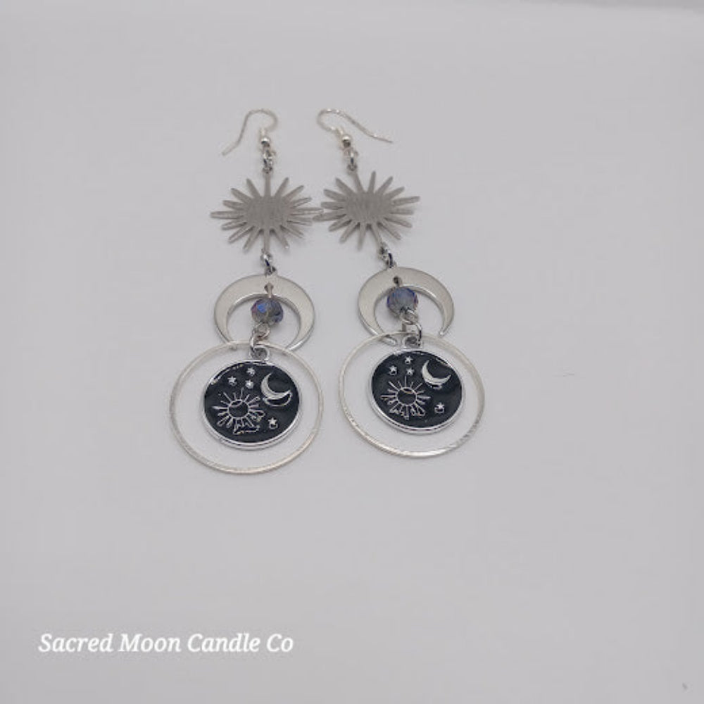Sacred Moon Candle Co celestial earrings for women featuring sun, moon, and star charms with silver hoops