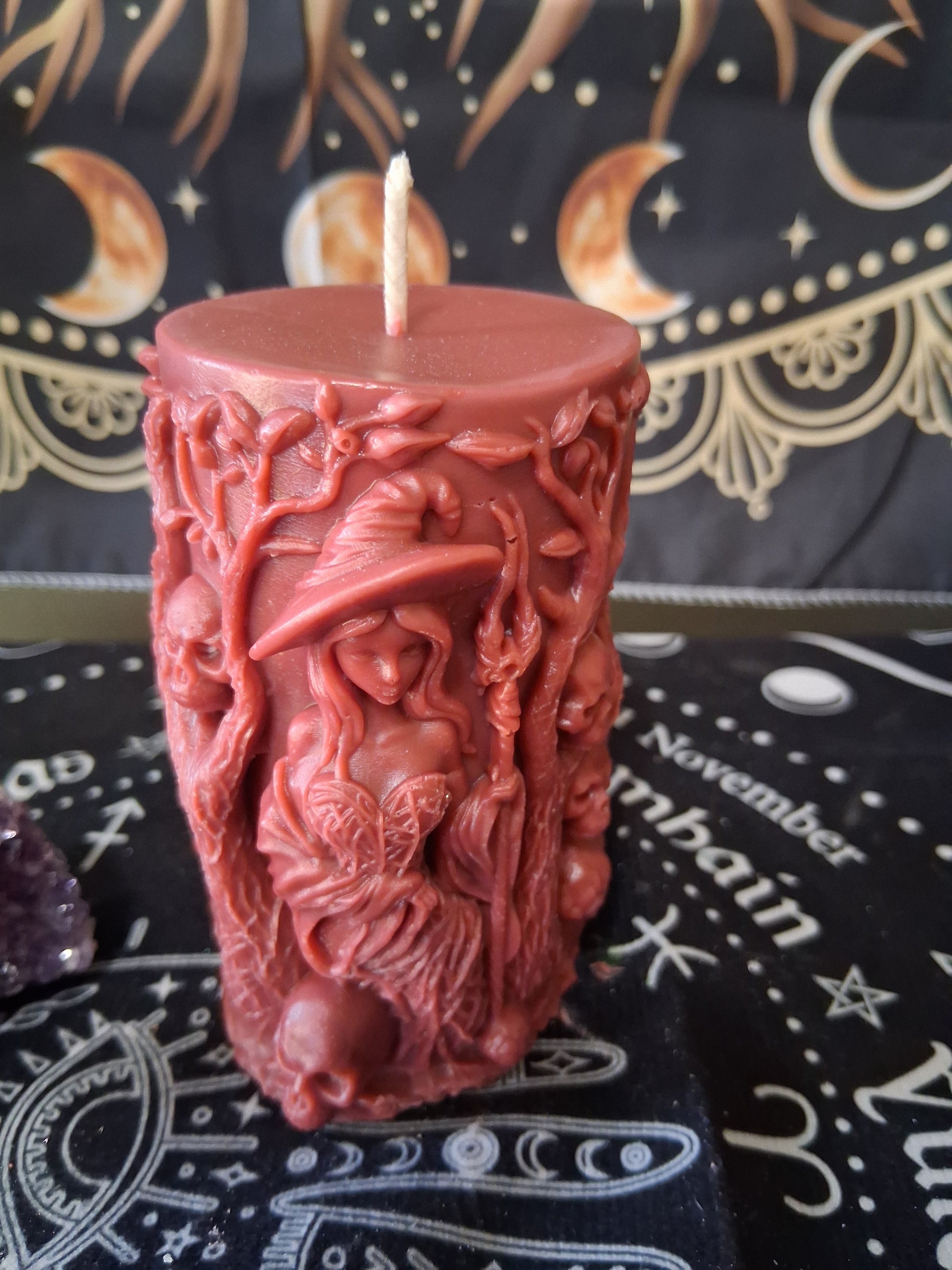 Siren's Blossom scented witch pillar candle by Sacred Moon Candle Co featuring detailed witch and nature design in dark red wax