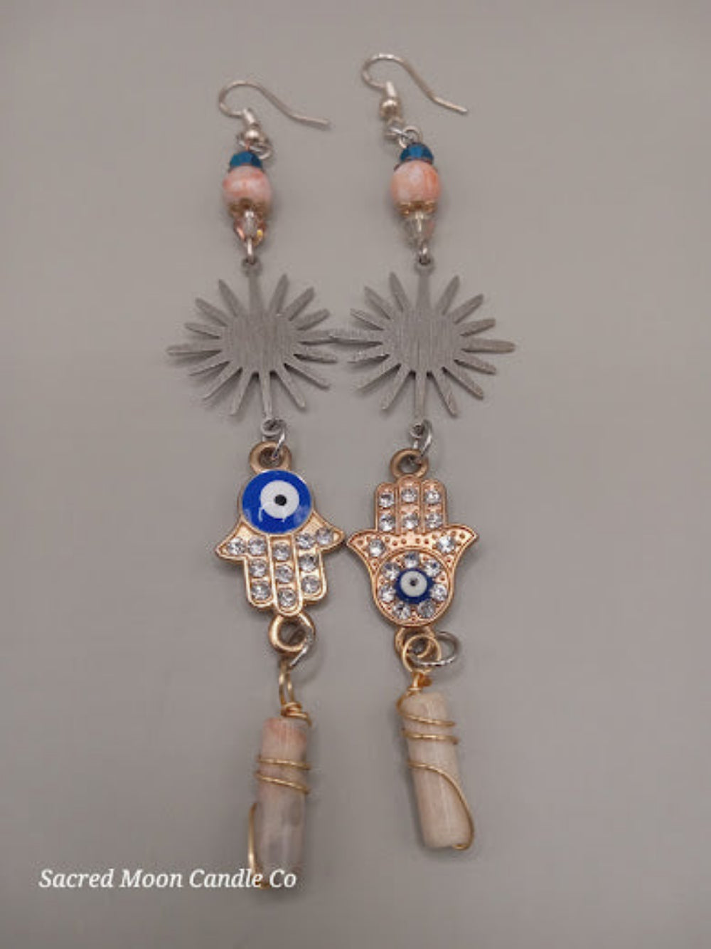 Sunburst Hamsa evil eye earrings by Sacred Moon Candle Co with crystal accents and dangling stone details