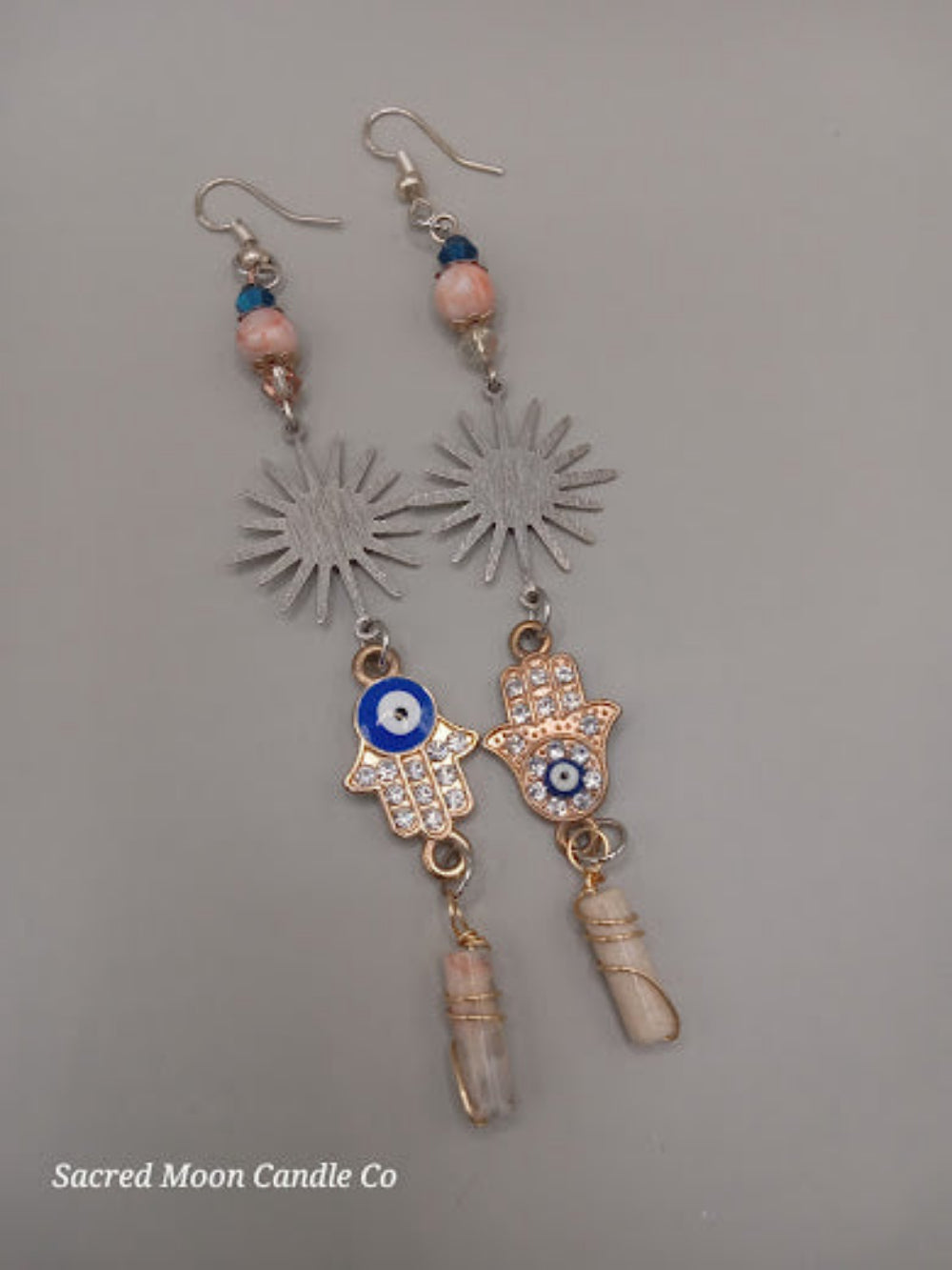 Sacred Moon Candle Co Sunburst Hamsa evil eye earrings with blue beads and crystal charms