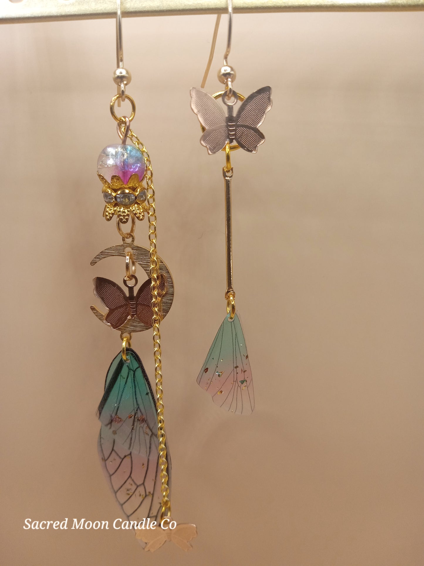 Sacred Moon Candle Co fairy wing earrings with butterfly charms and delicate pastel wings