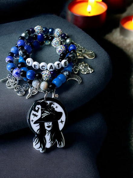 Hecate charm bracelet by Sacred Moon Candle Co with black blue beads and witch-themed pendant