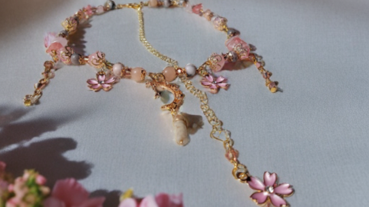 Sacred Moon Candle Co sakura blossom moon choker with pink flowers and gold chain details