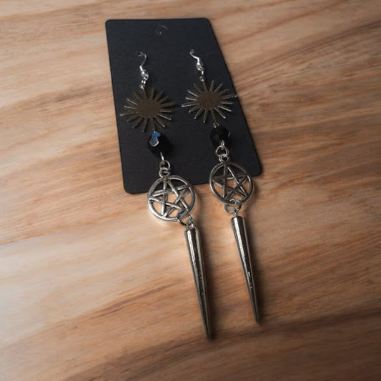 Sacred Moon Candle Co sunburst pentacle earrings with black bead and spike charm on black card