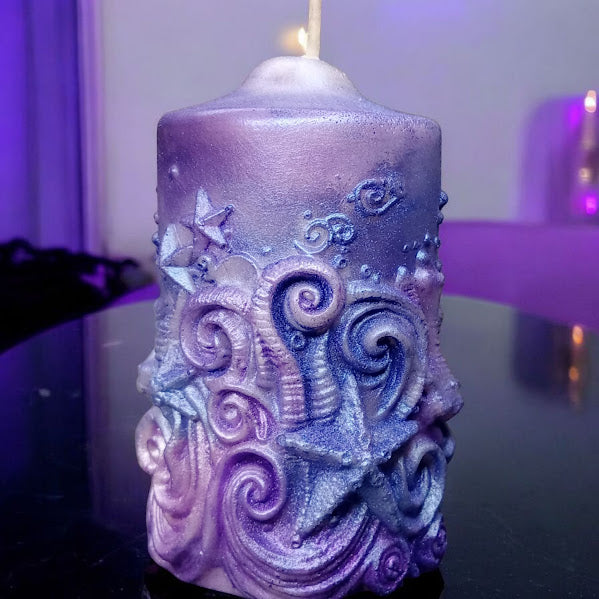 Sacred Moon Candle Co water lily jasmine scented candle with intricate starfish and swirl design in purple