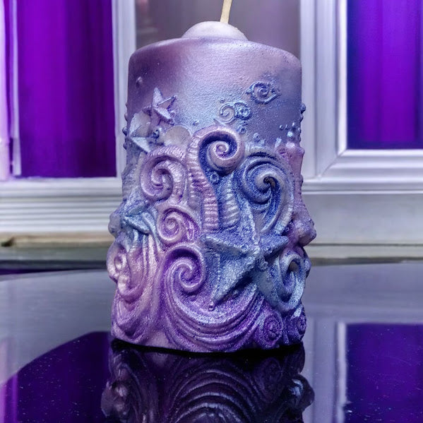 Purple Sacred Moon Candle Co water lily jasmine scented candle with intricate ocean wave and starfish design