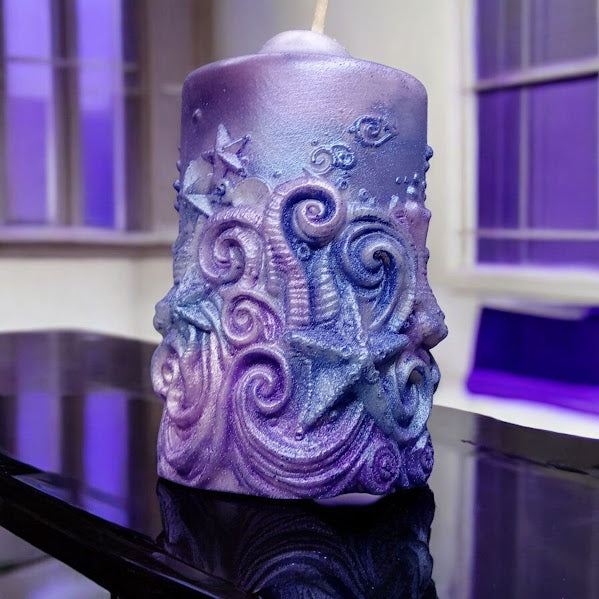 Purple and blue decorative candle with starfish design Sacred Moon Candle Co water lily jasmine scented candle