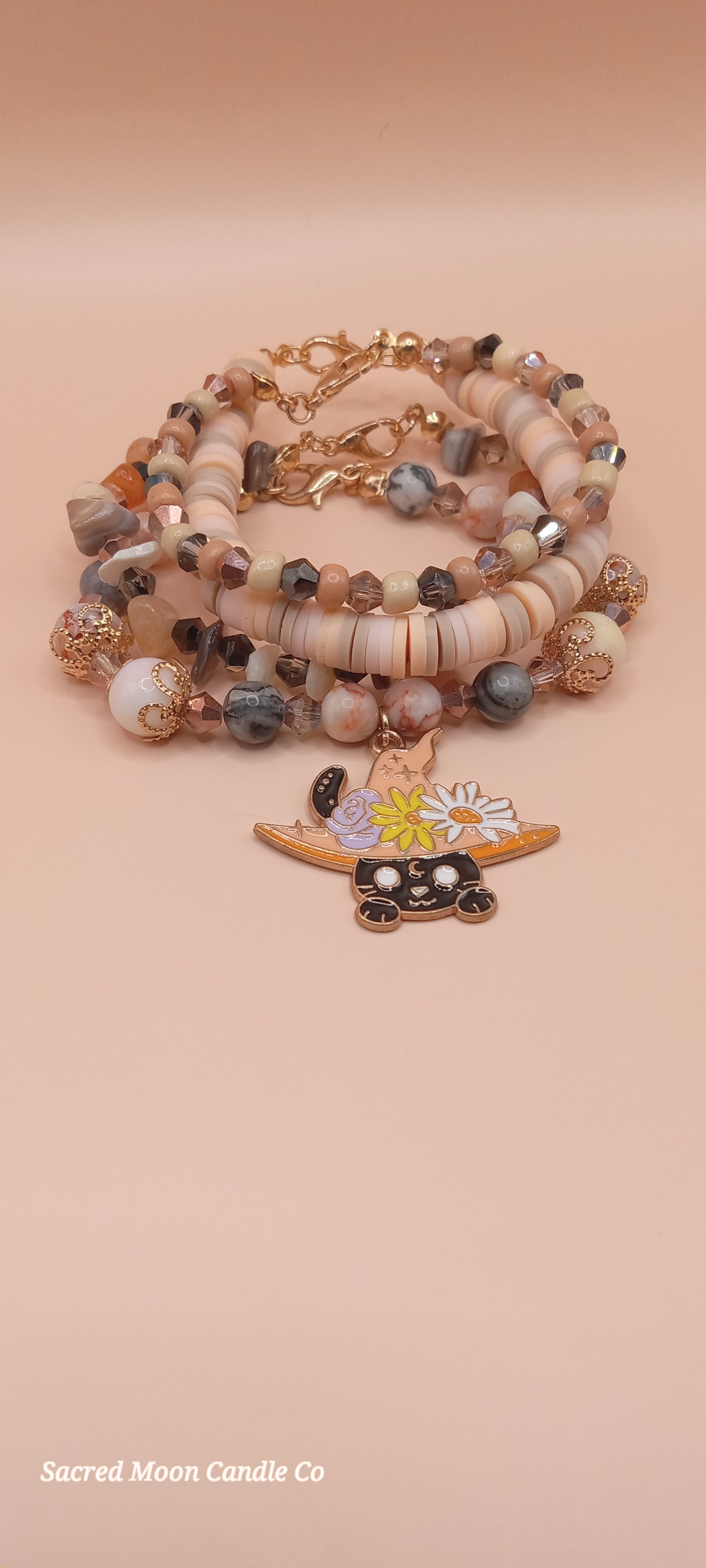Witchy cat charm bracelet with earthy beads and gold accents by Sacred Moon Candle Co