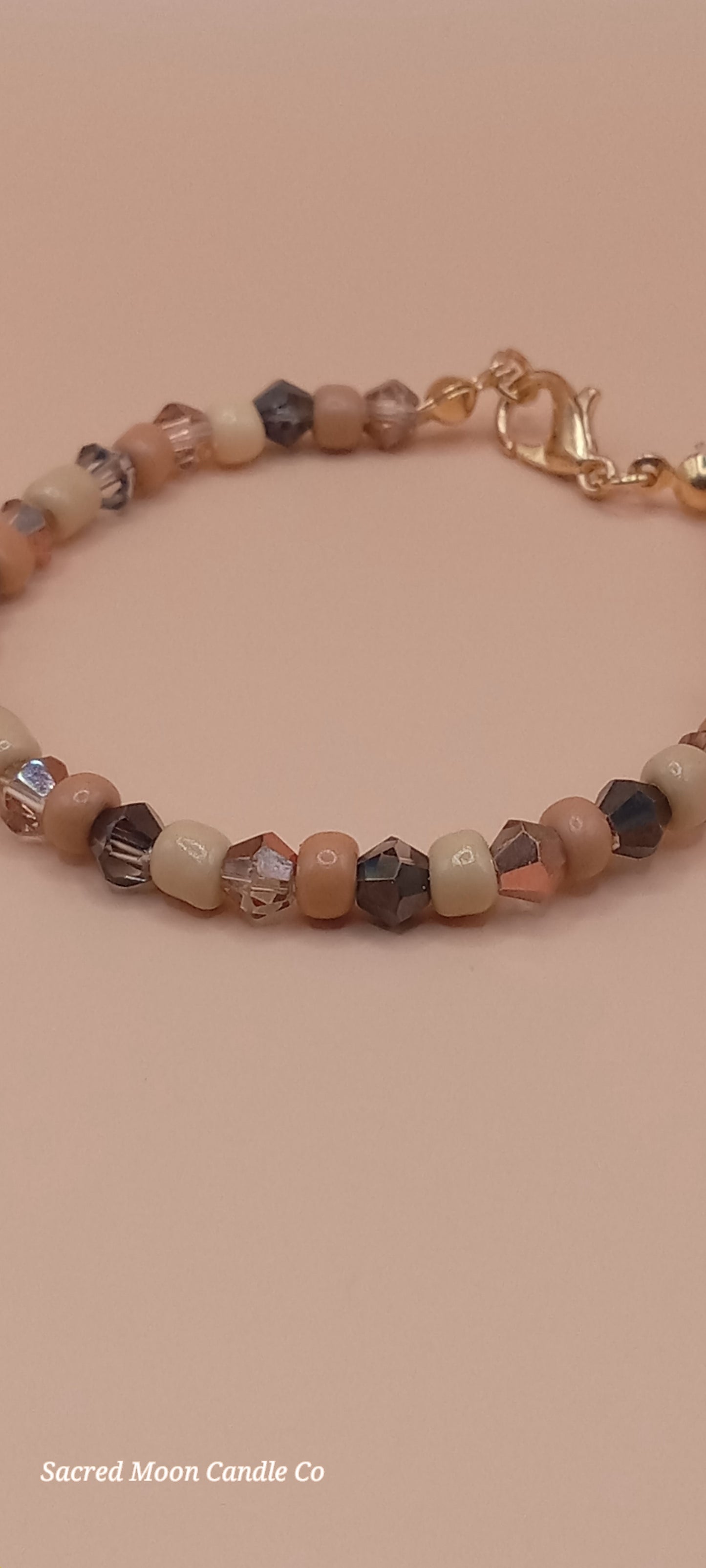 Sacred Moon Candle Co witchy cat charm bracelet with mixed beige and brown beads and gold clasp