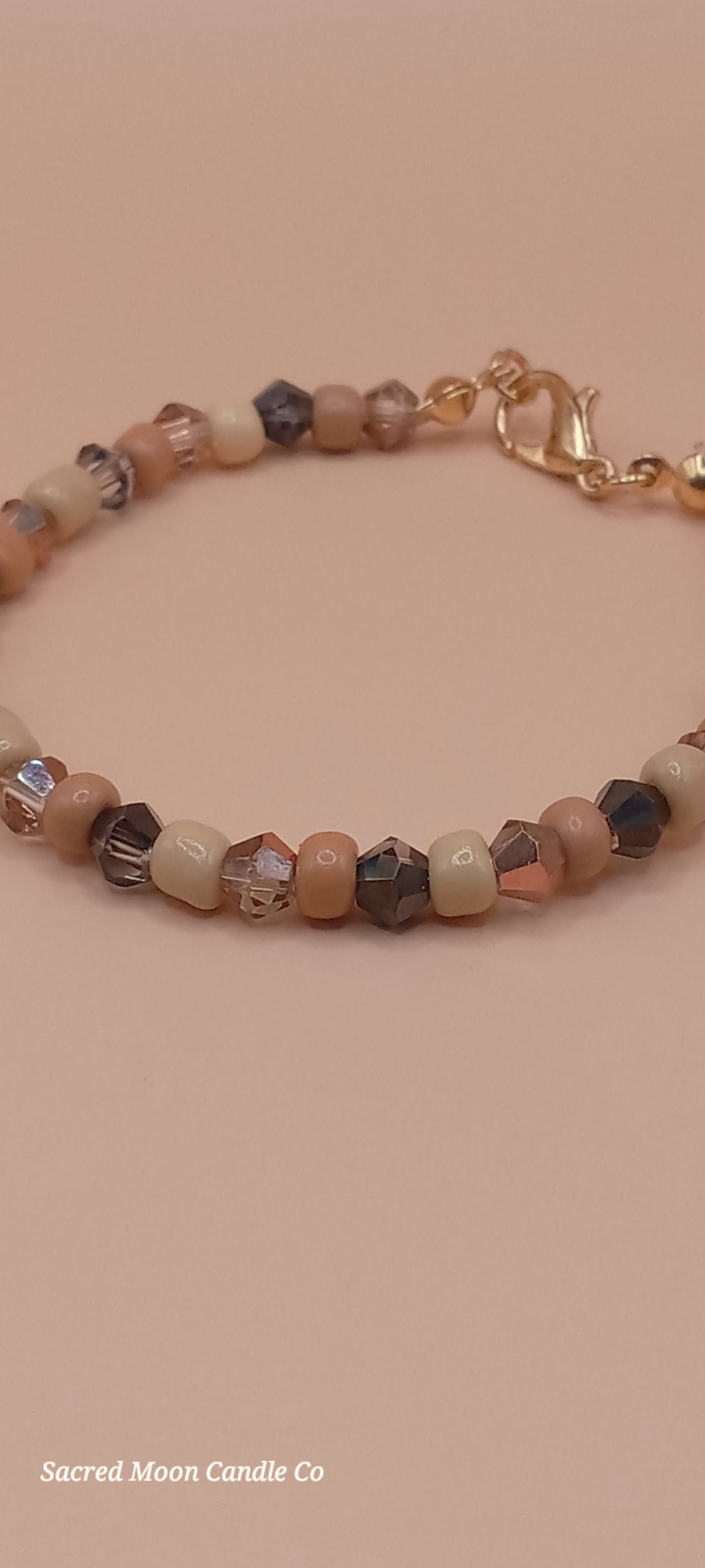 Sacred Moon Candle Co witchy cat charm bracelet with mixed beige and brown beads and gold clasp