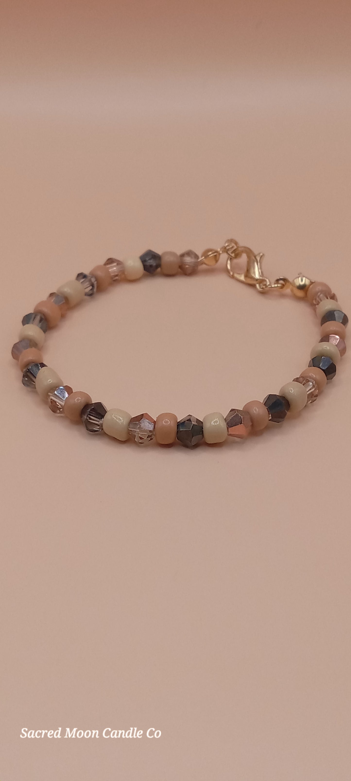 Sacred Moon Candle Co witchy cat charm bracelet with multicolored bead stack and gold clasp