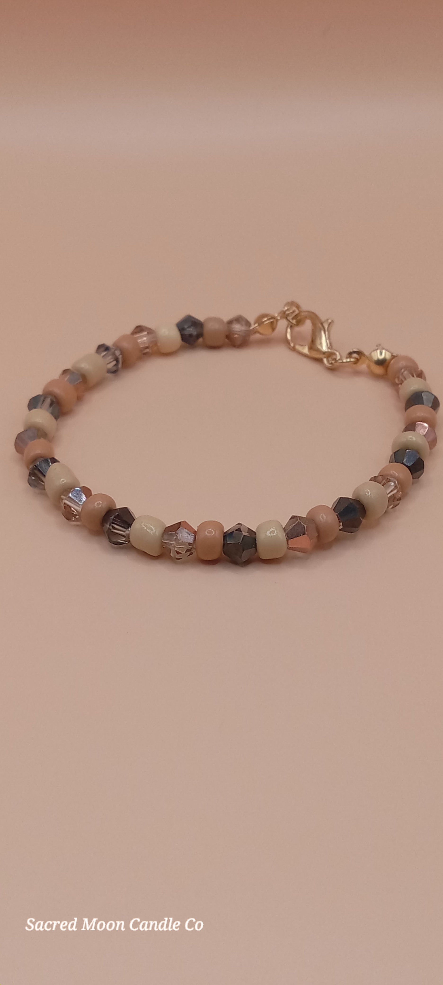 Sacred Moon Candle Co witchy cat charm bracelet with multicolored bead stack and gold clasp