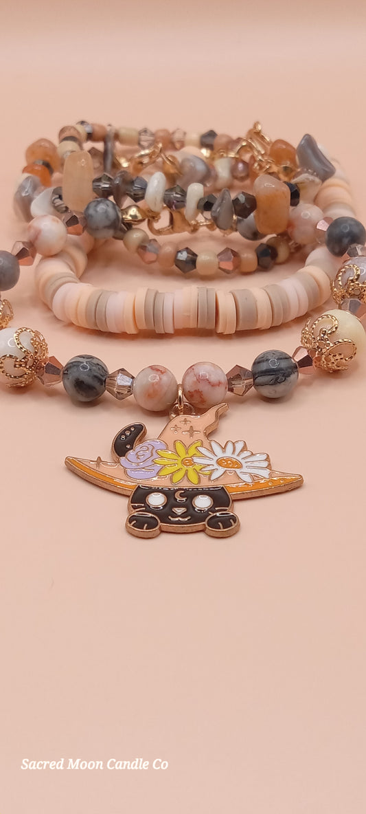 Sacred Moon Candle Co bracelet stacks featuring a witchy cat charm bracelet with assorted beads and charms